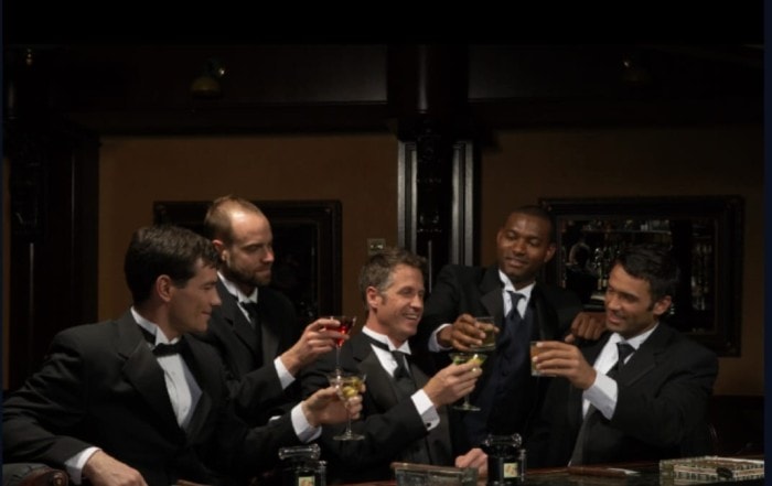 guys drinking a cocktail and discussing budget on bachelor party