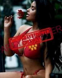 latina girl in a red bikini smelling a rose