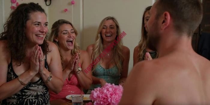 Group of women cheering during a private male stripper show at a Miami bachelorette party