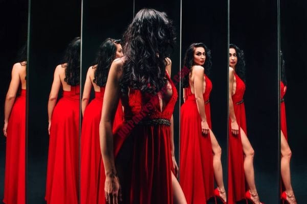 Modern stripper adjusting outfit in backstage dressing room before a VIP party
