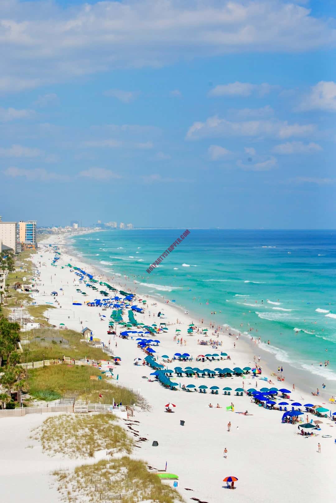 featured-image-1748975431 | Hot Party Stripper A beach with umbrellas and people on it.