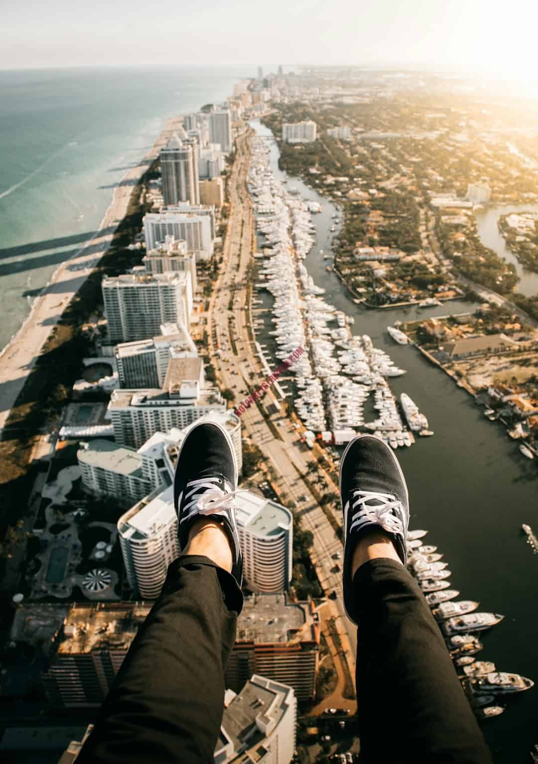 featured-image-1748979185 | Hot Party Stripper A person sitting on the edge of a building overlooking a city.