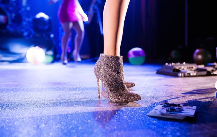 A woman's legs in high heels on a stage.