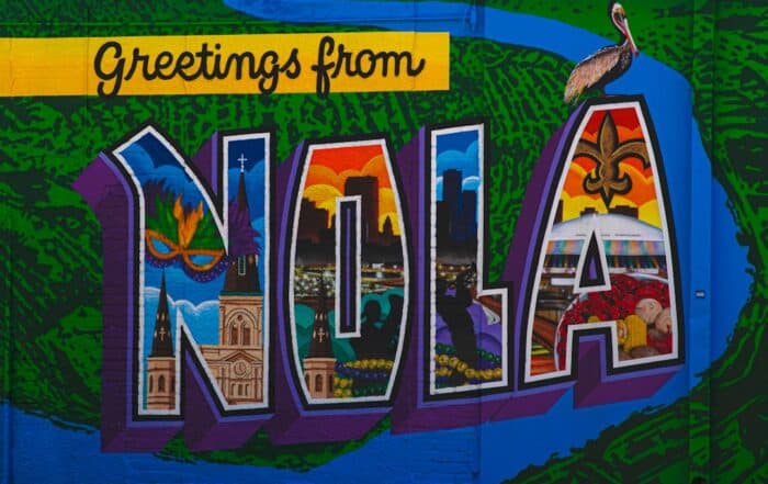 featured-image-1749214867 | Hot Party Stripper A colorful mural of the word nola on a building.