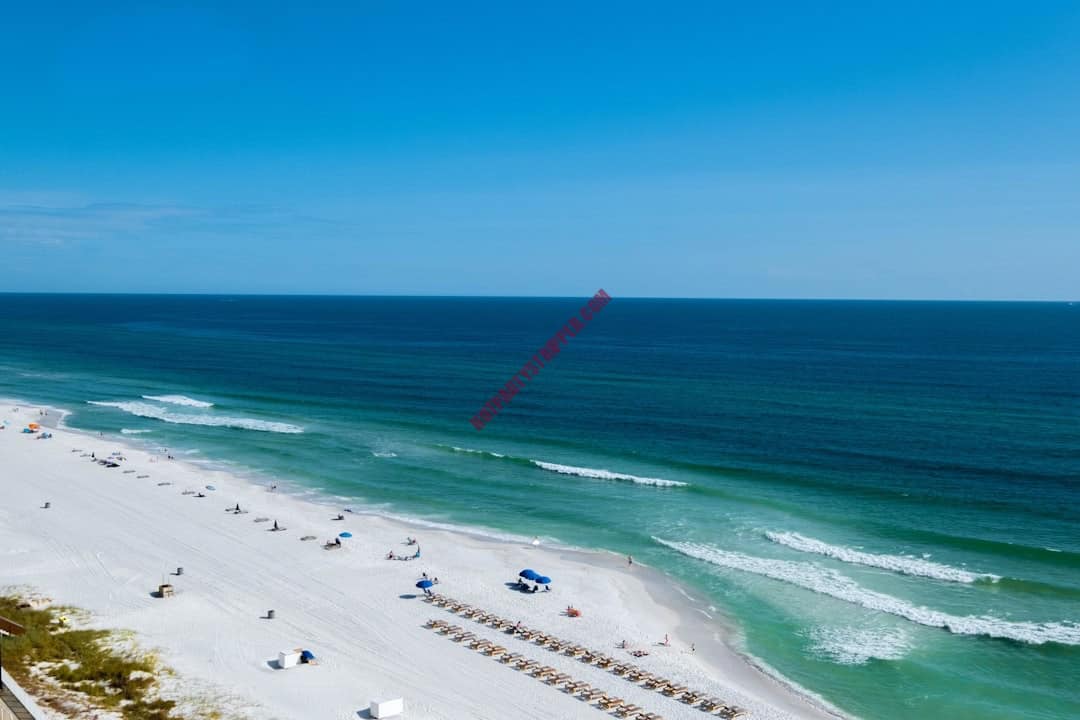 Ocean with chairs and umbrellas in Panama City beach Florida