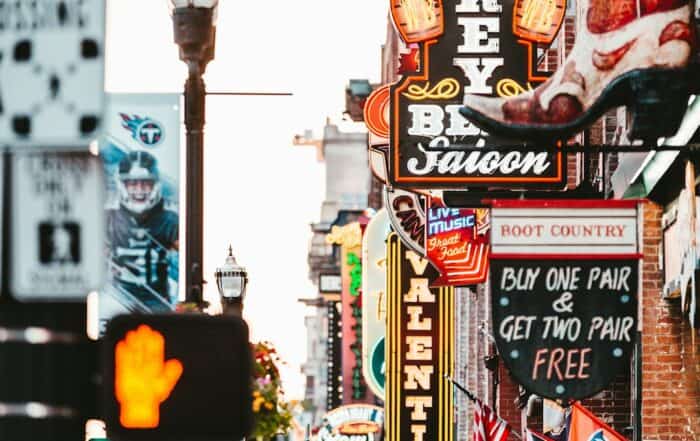 featured-image-1749474069 | Hot Party Stripper A busy city street in Nashville with many people walking and cars driving.