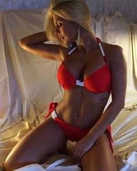 Sexy Key West female stripper in bikini entertaining a group during a beach party