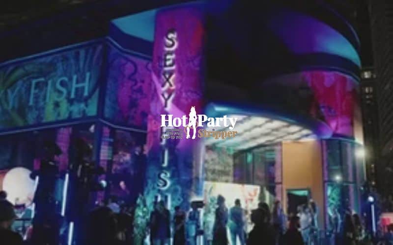 Sexy Fish Miami exterior at night in Brickell with colorful illuminated entrance and nightlife crowd