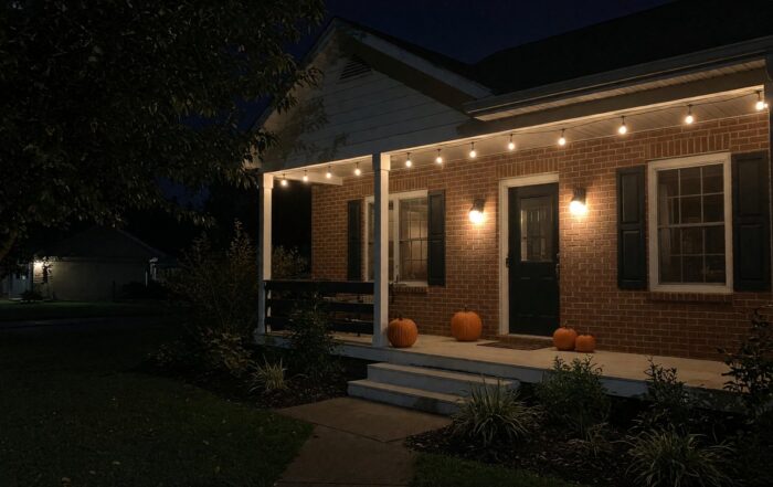 Franklin Halloween rental house at night | Hot Party Stripper Brick rental house in Middle Tennessee at night with porch pumpkins and string lights